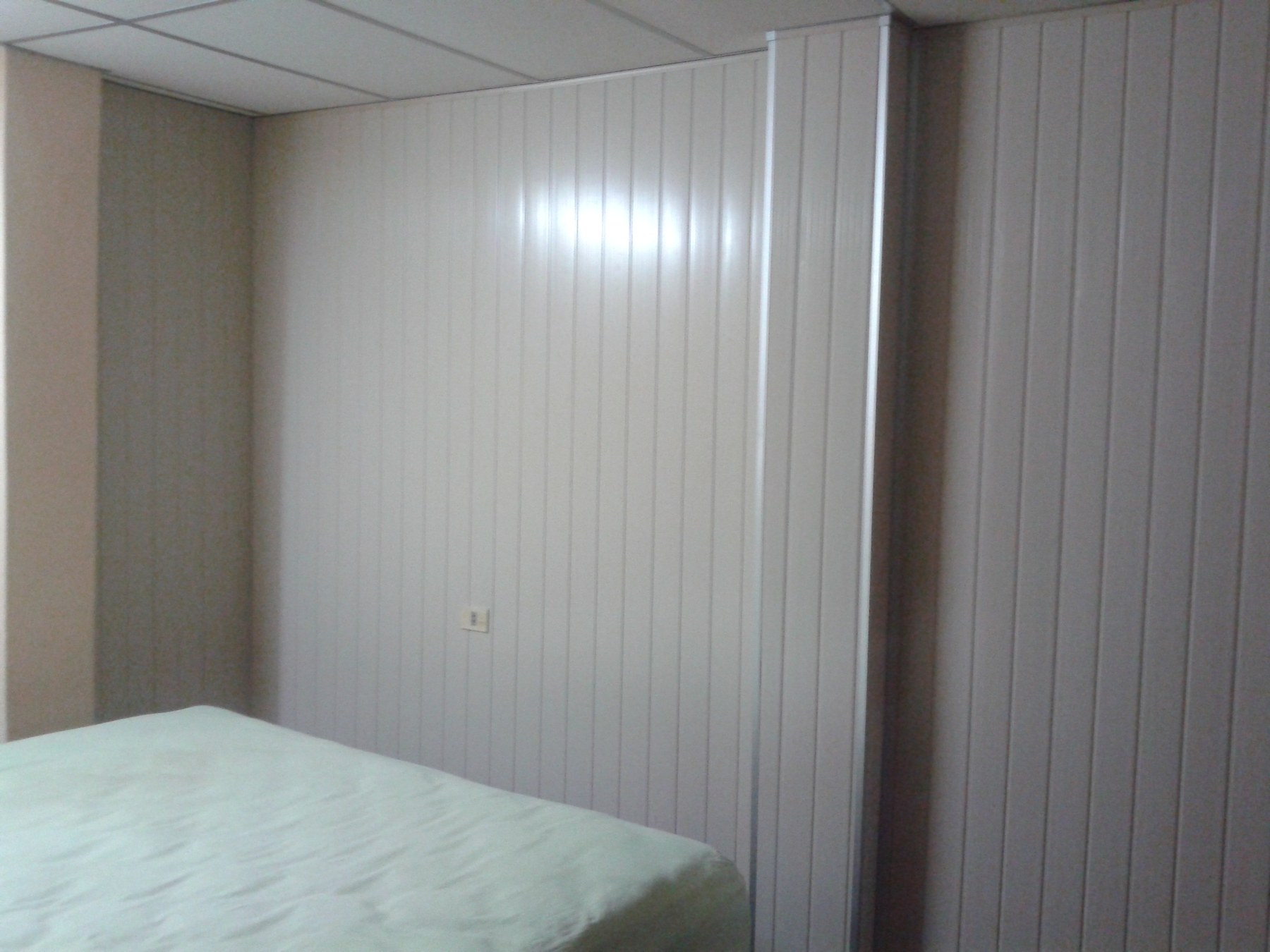 Paredes revestidas en machimbre de PVC blanco en dormitorio con cielo raso desmontable · MÁS VIDRIOS