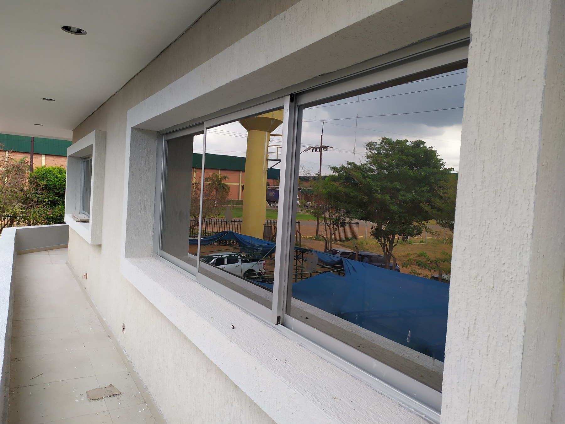 Ventana corrediza de aluminio en la galería de un edificio · MÁS VIDRIOS